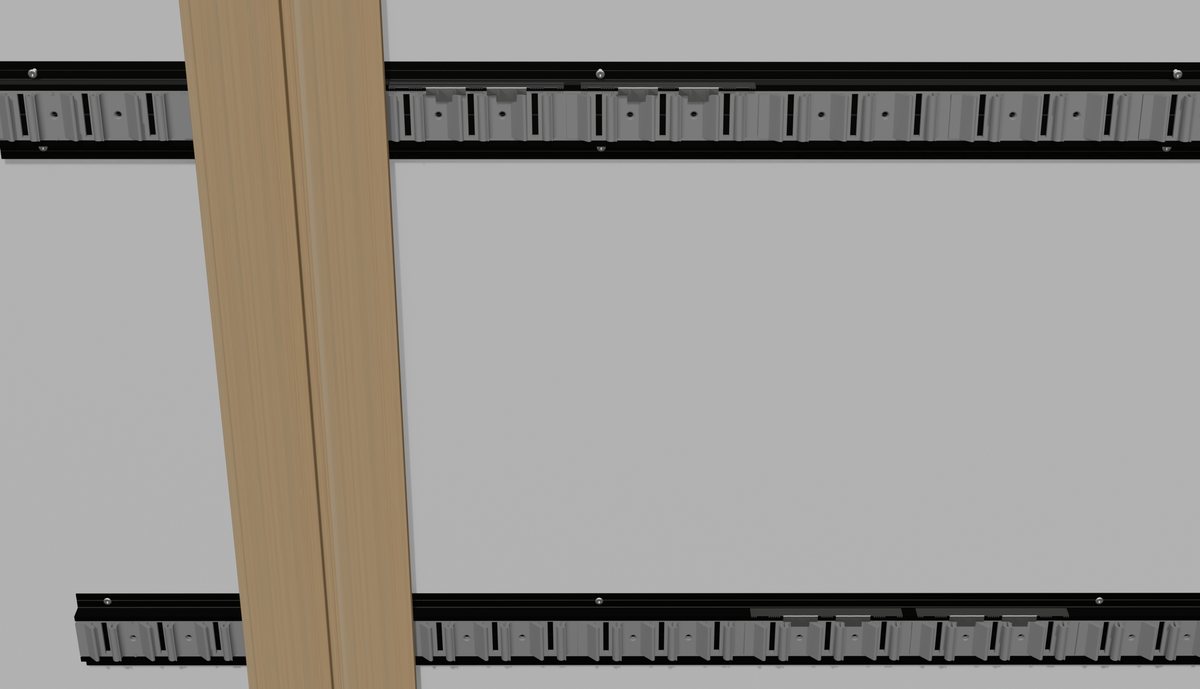 Two aluminium rails with clips on the wall, a vertical batten in front